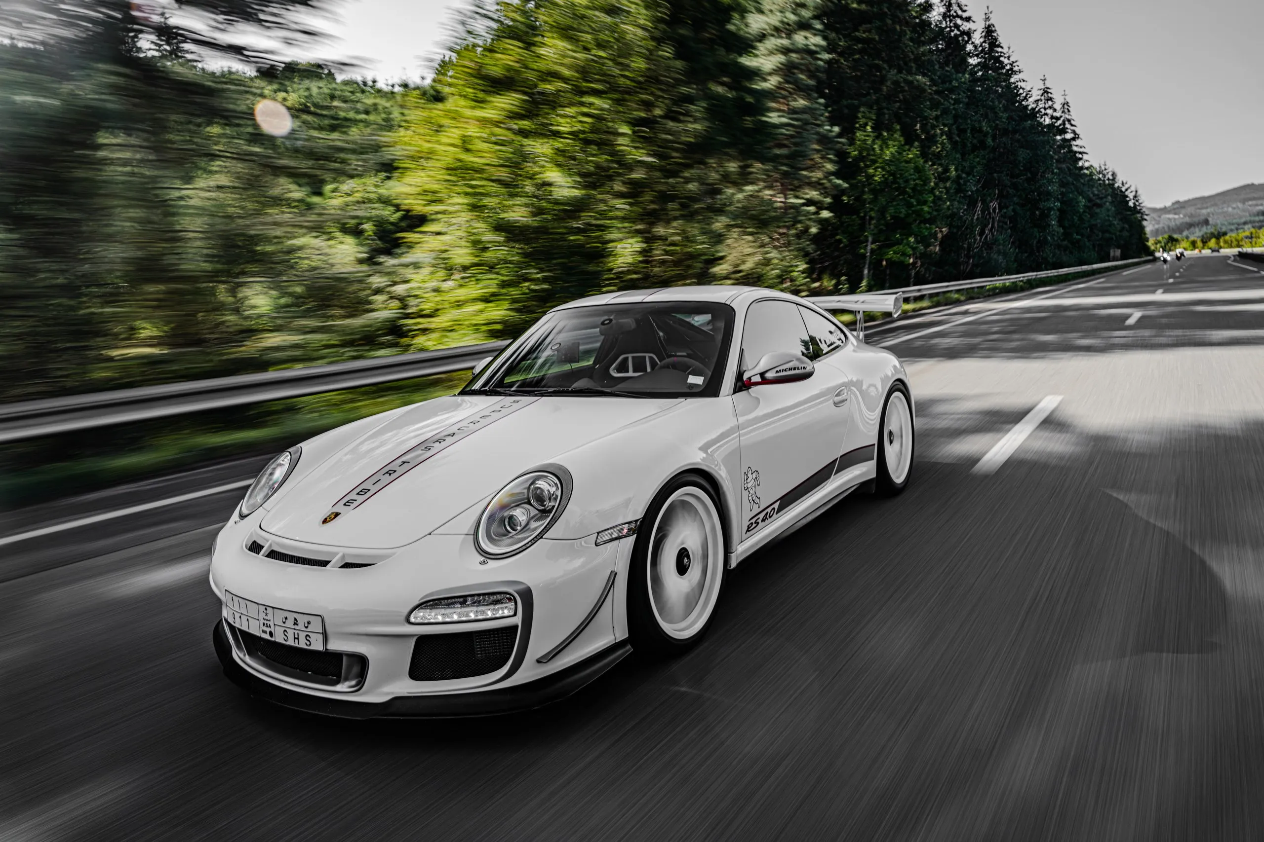 White Porsche 911 at speed