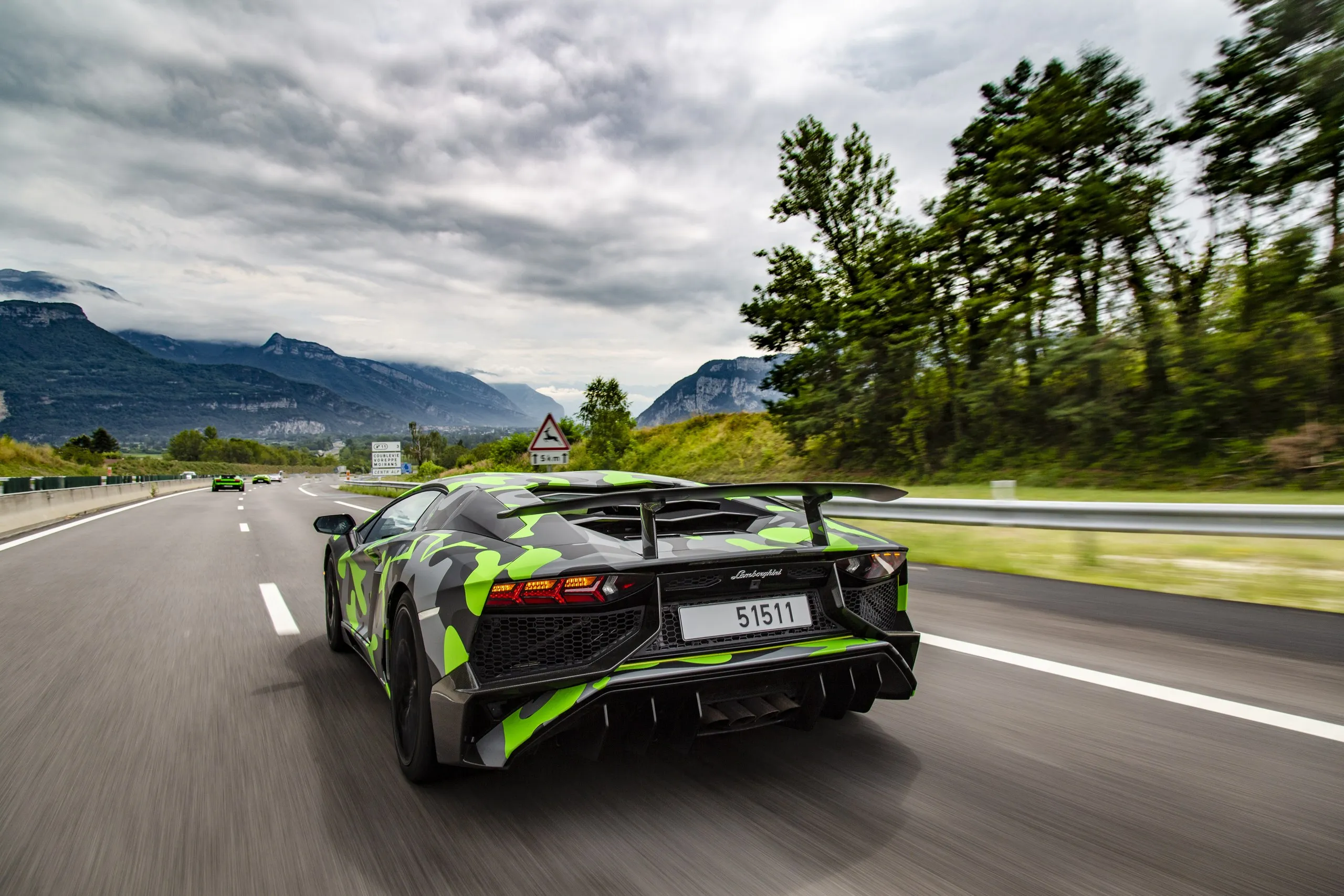 Race car in camouflage livery on track