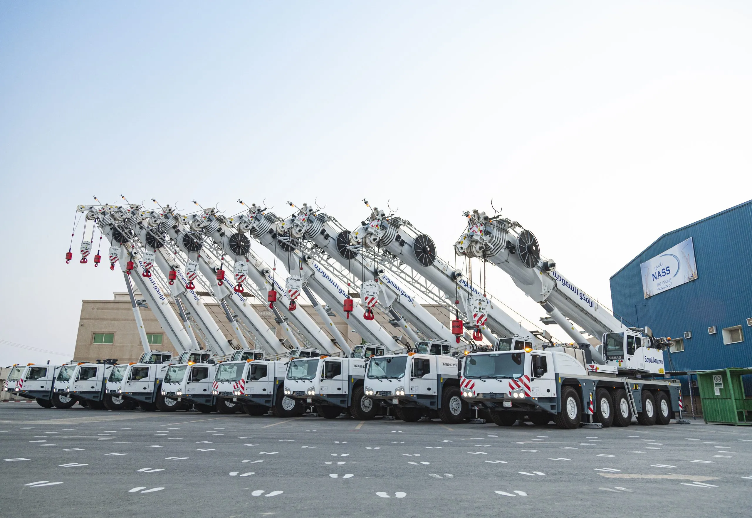 Fleet of concrete pump trucks lined up