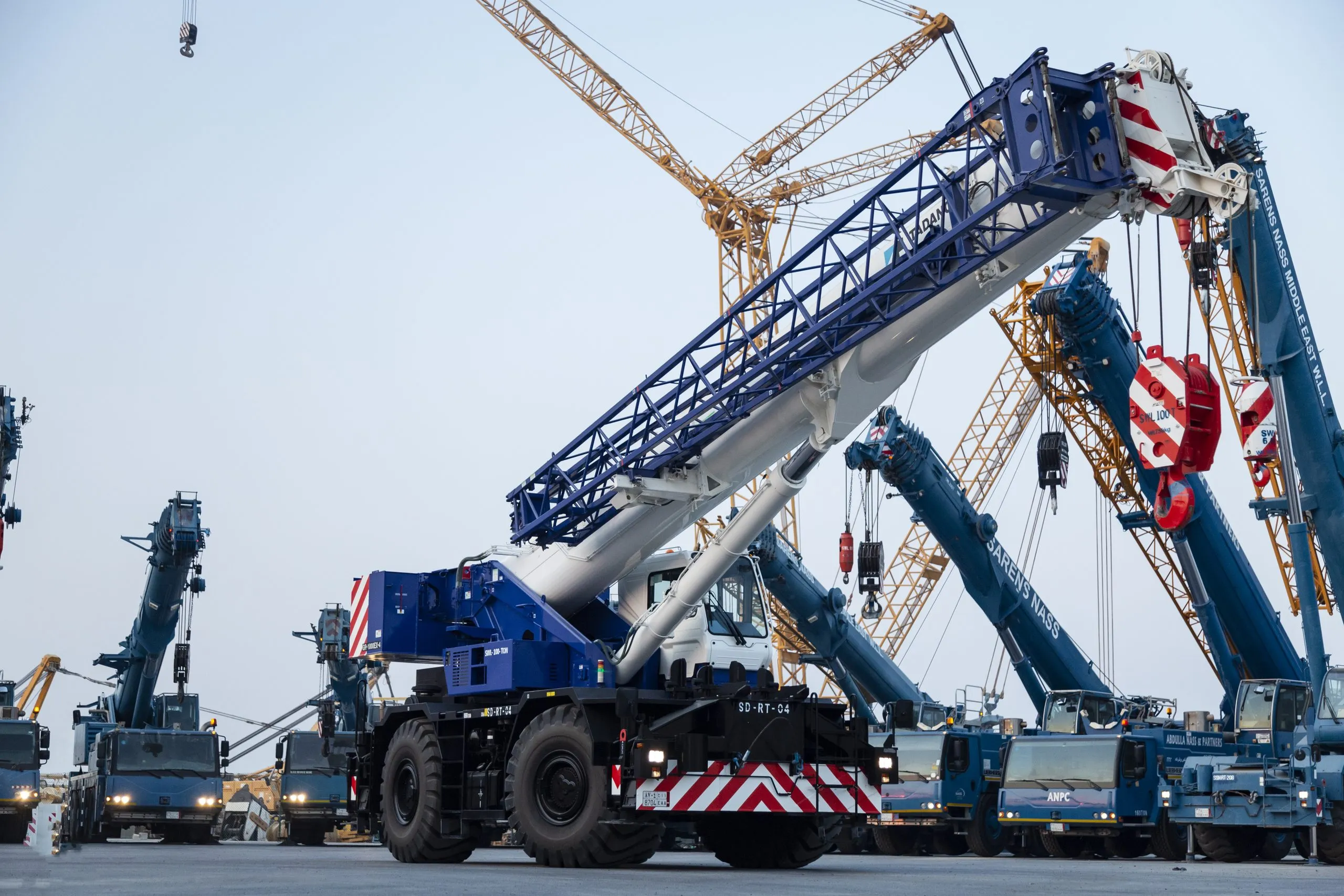 Mobile crane at a construction yard, towers behind