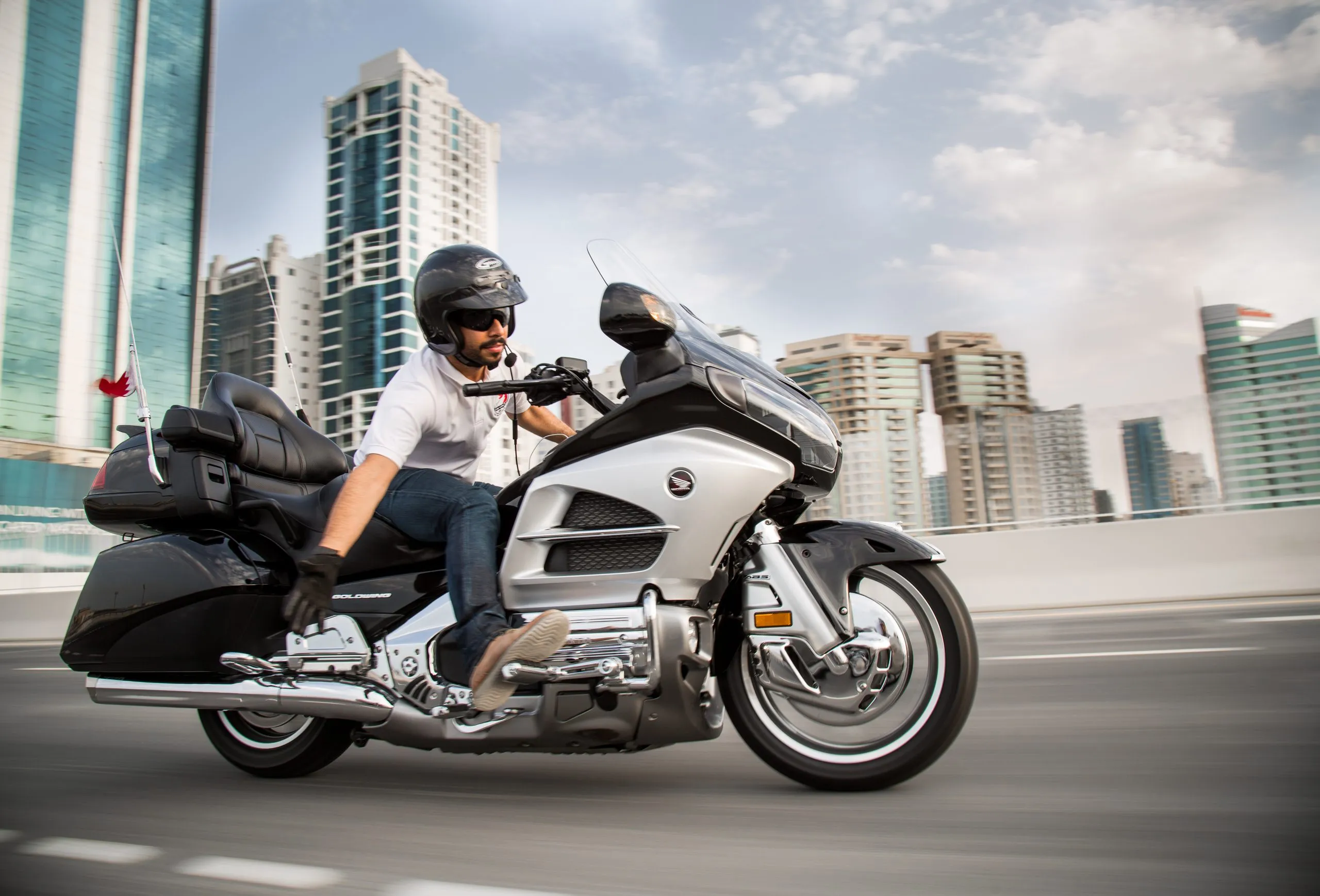Motorcyclist riding a touring bike through the city