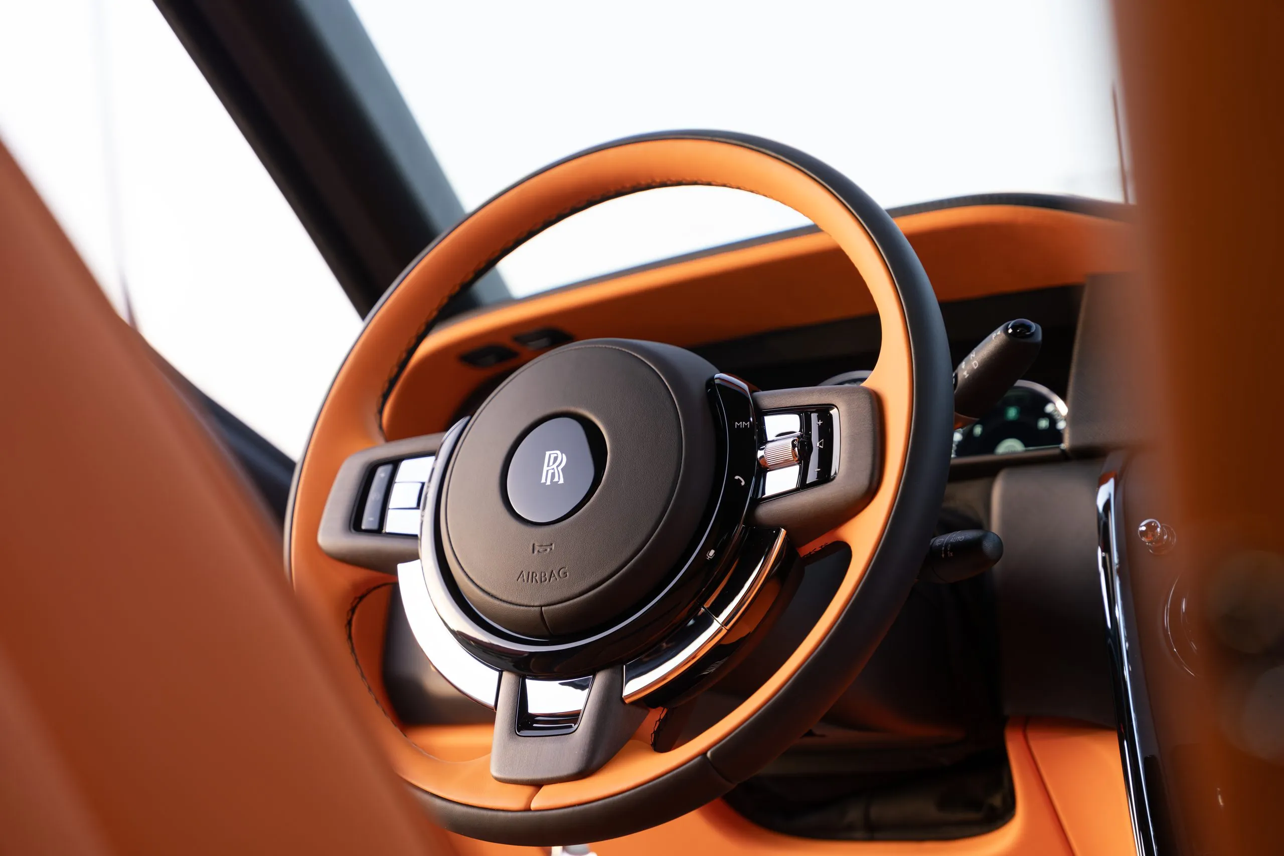 Orange leather steering wheel and dashboard detail