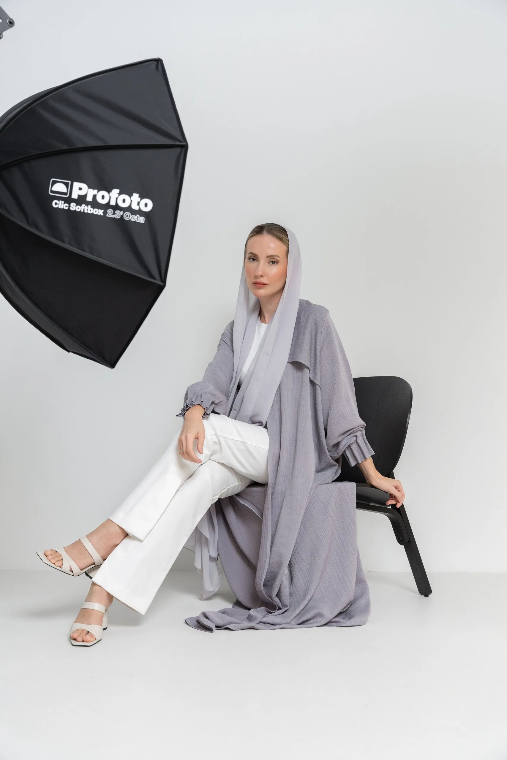 Woman in a lilac abaya in studio light