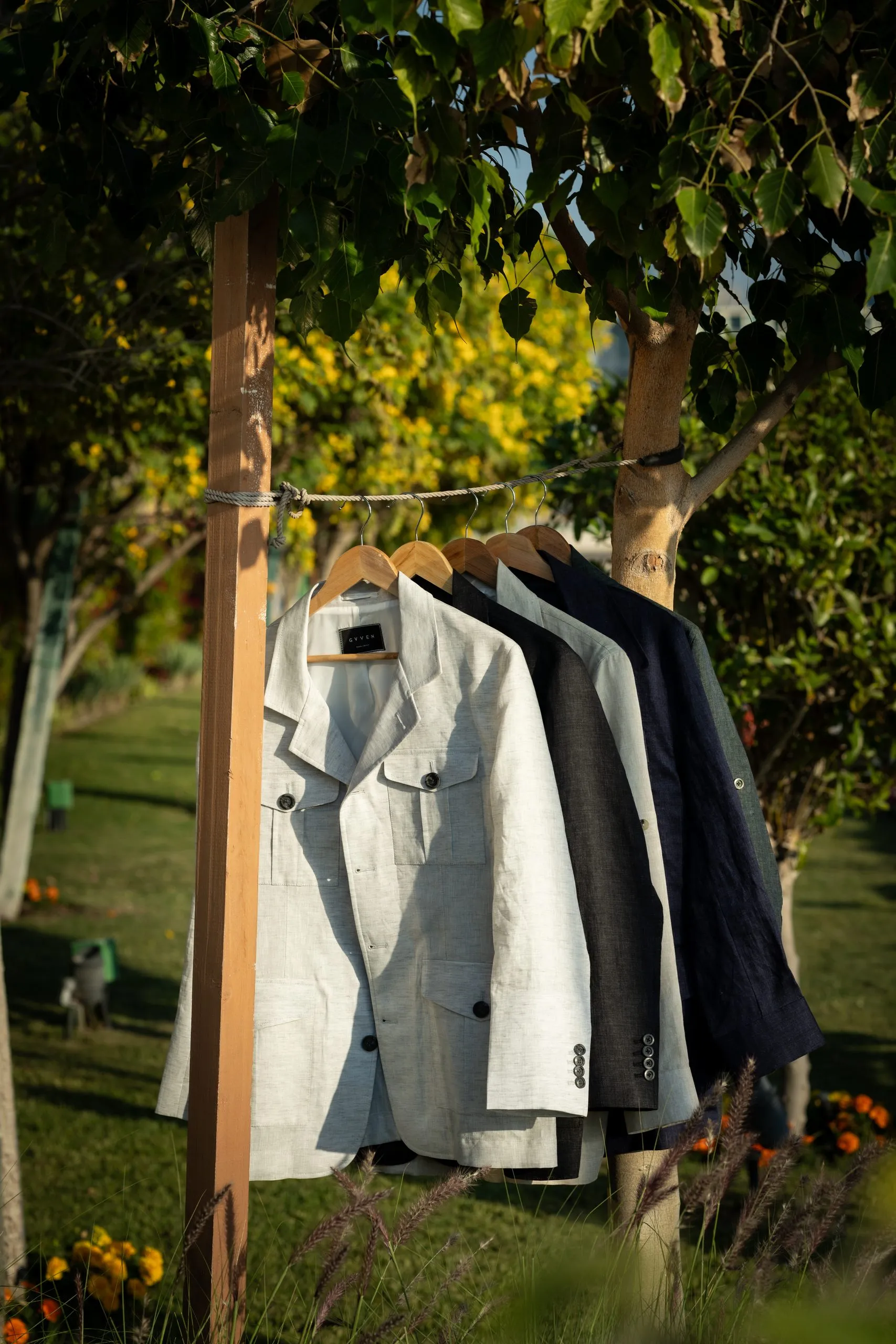 Suit jacket hanging on a garment rack in a garden
