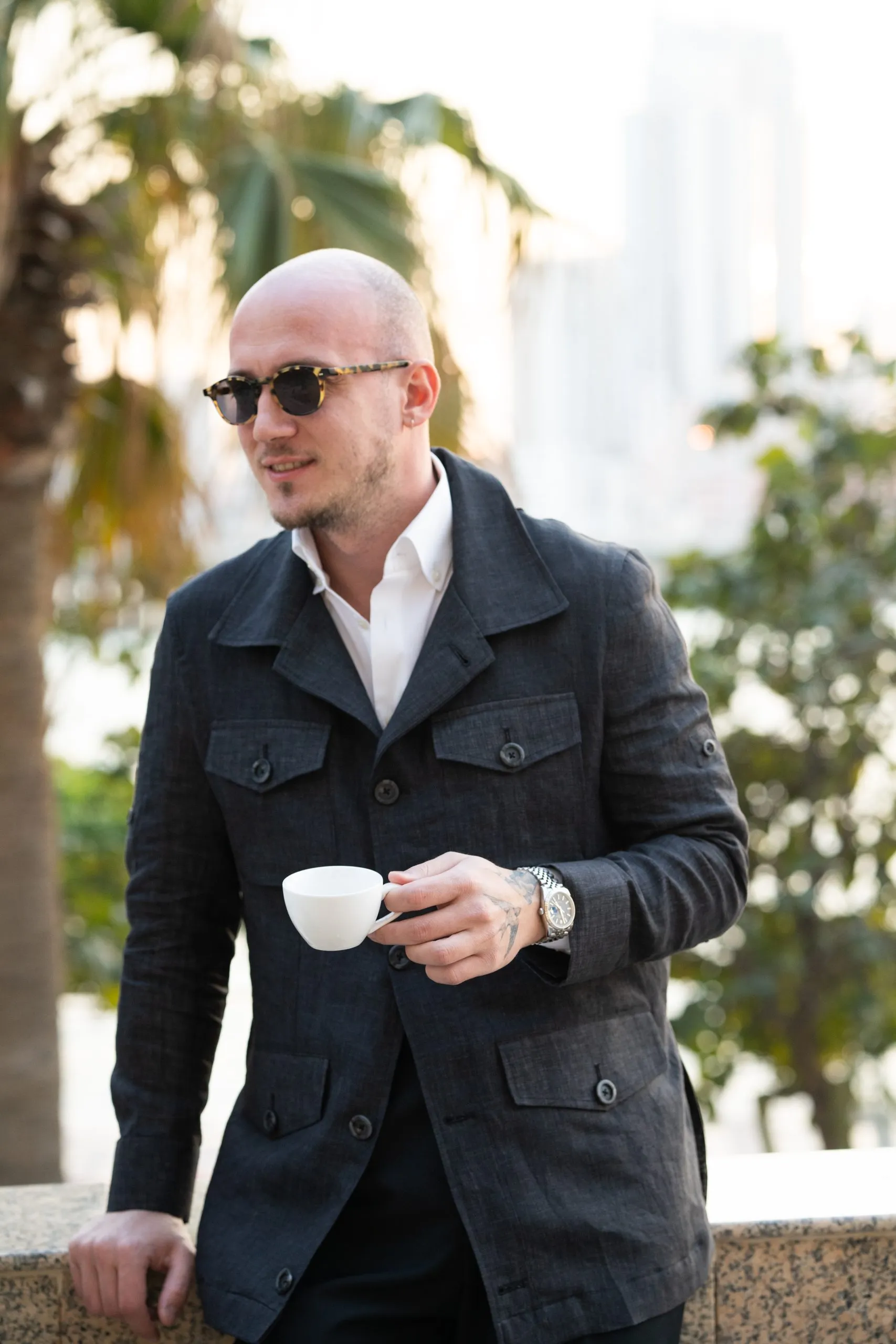 Man in sunglasses pausing over coffee