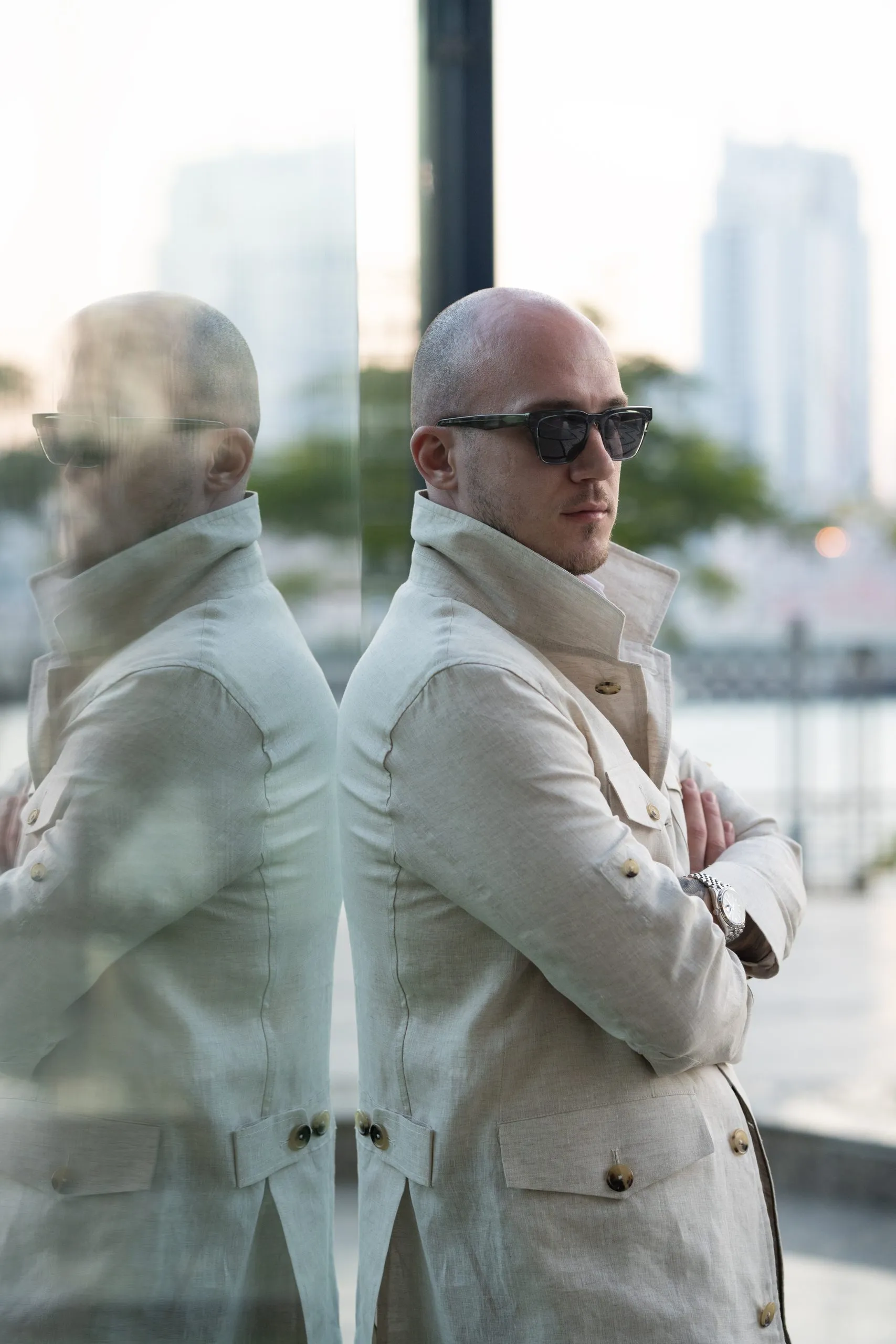 Man in a white blazer reflected in glass