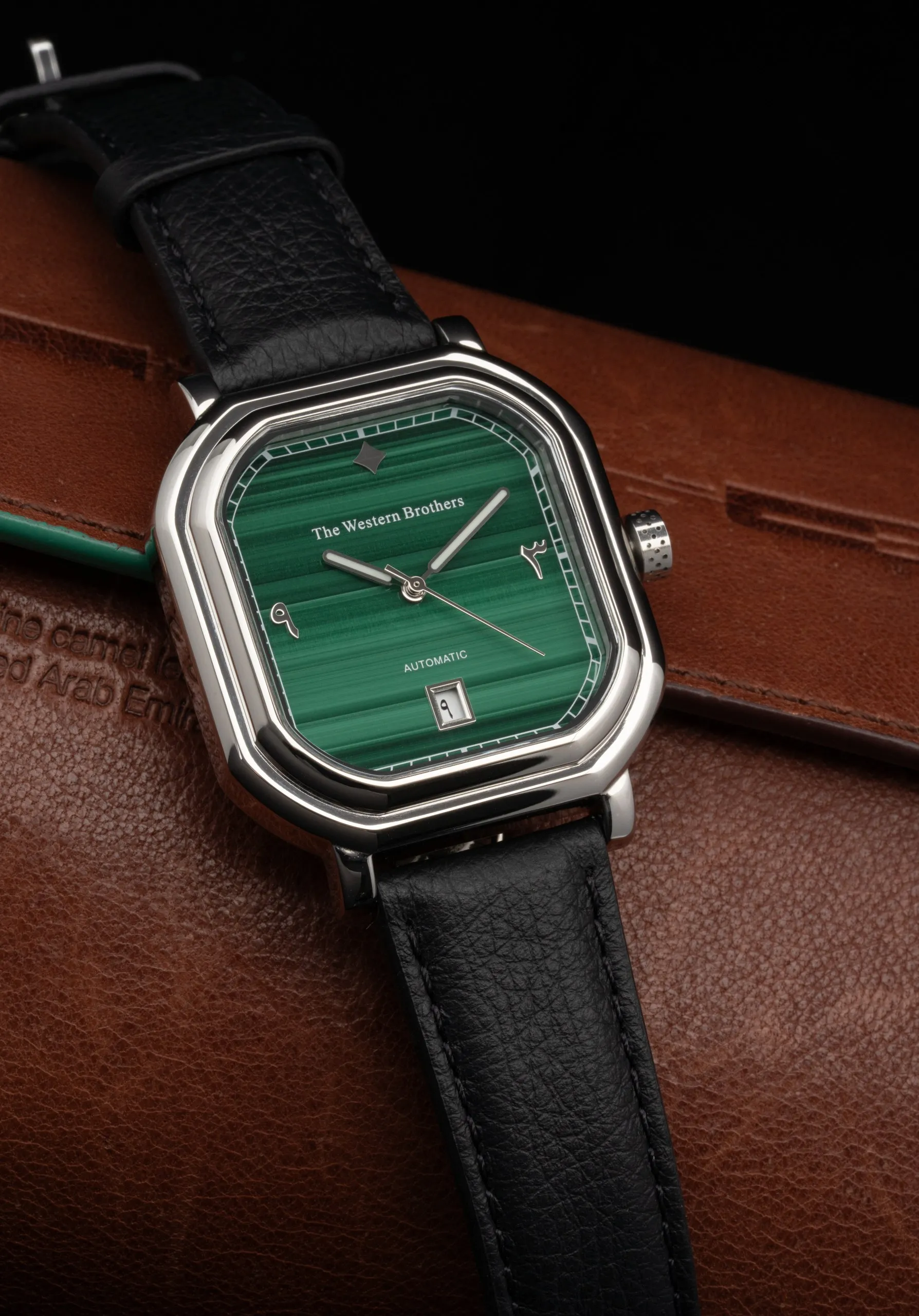 Wristwatch with a green sunburst dial