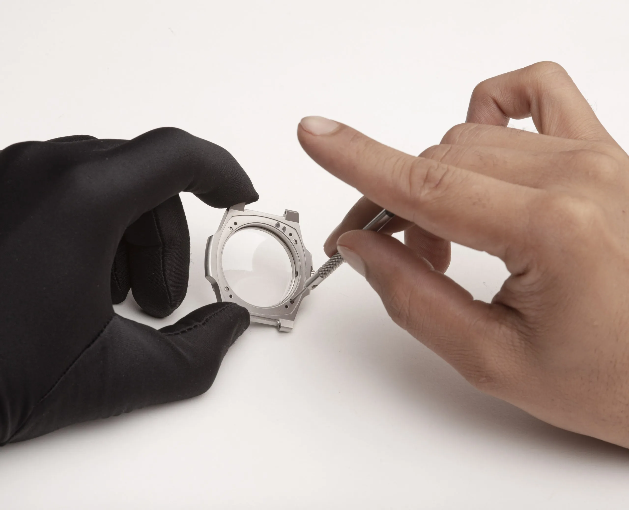 Hand wearing a watch, adjusting a shirt cuff