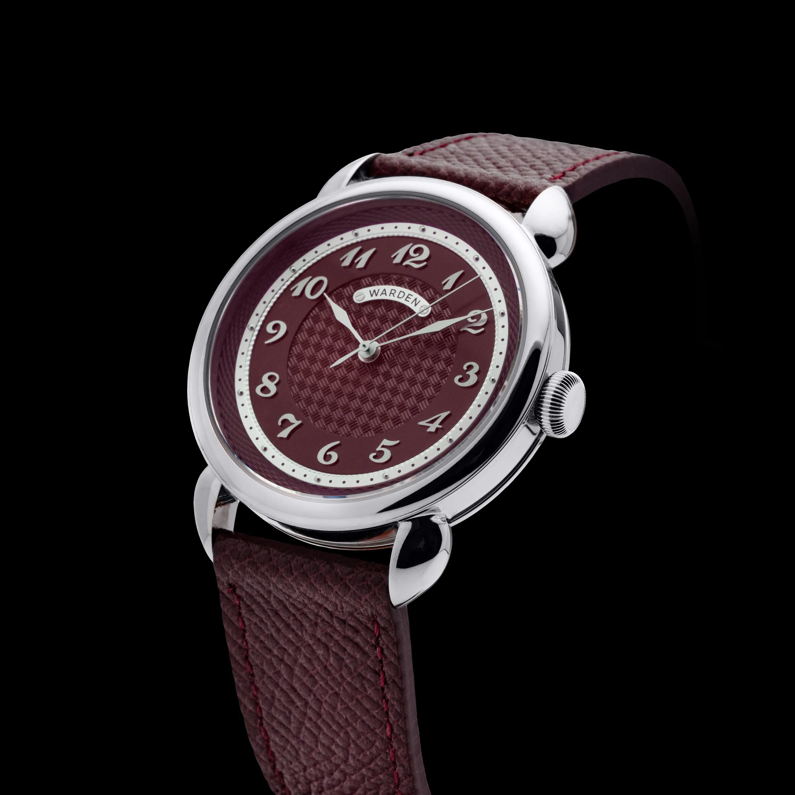 Wristwatch with a burgundy patterned dial