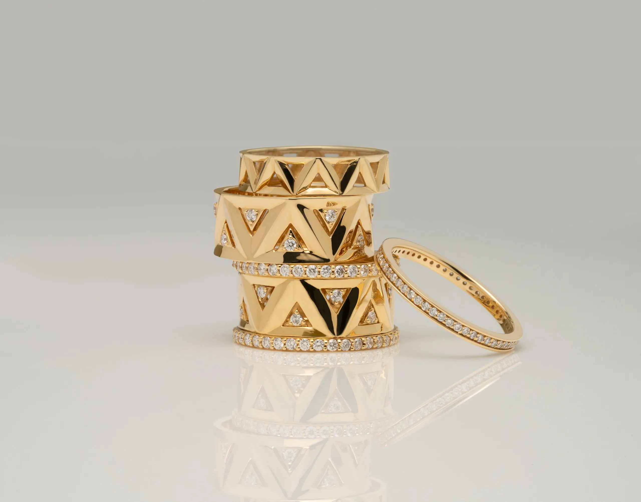 Stacked gold Greek-key bangles