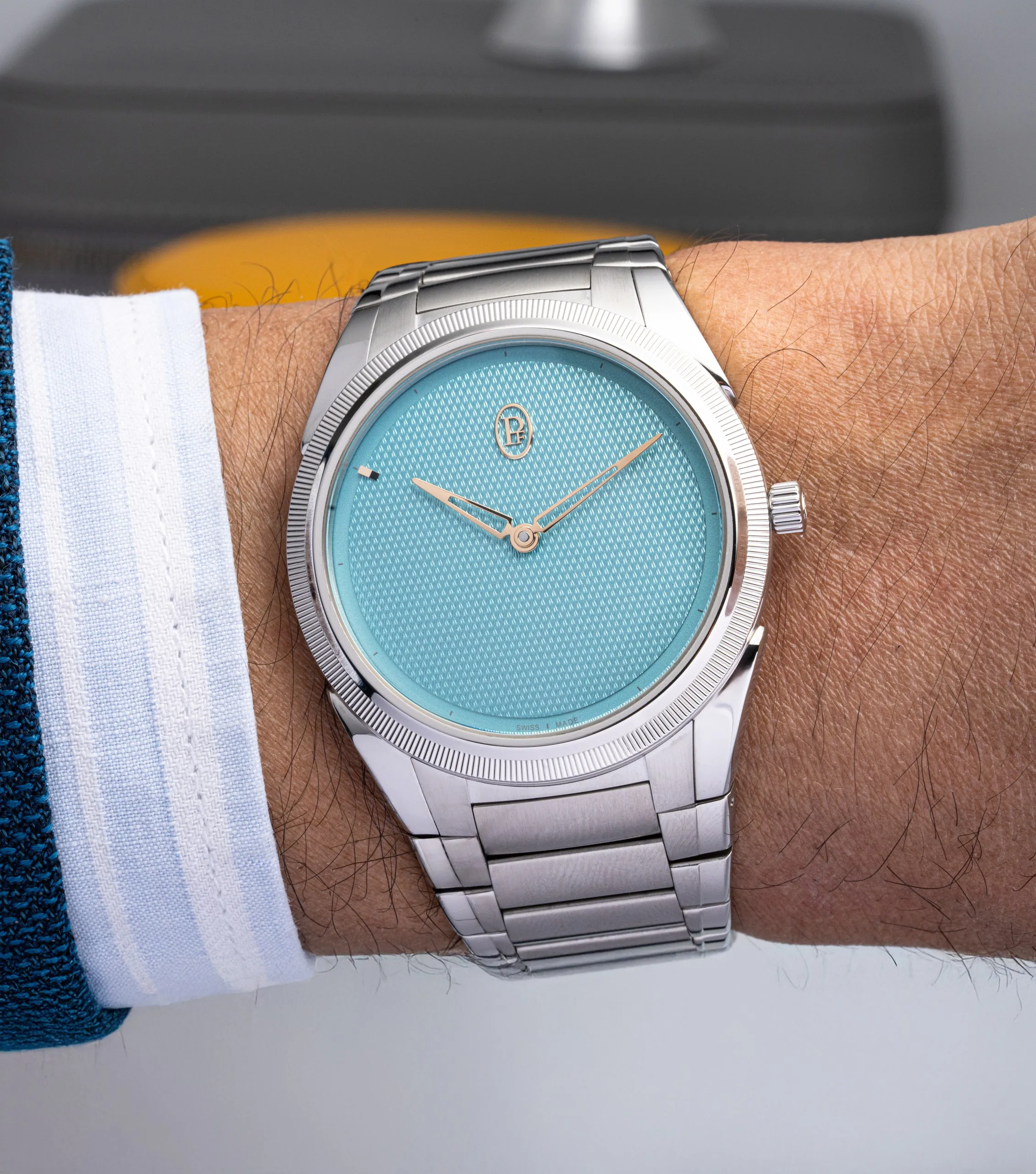 Watch with a pale blue dial on the wrist
