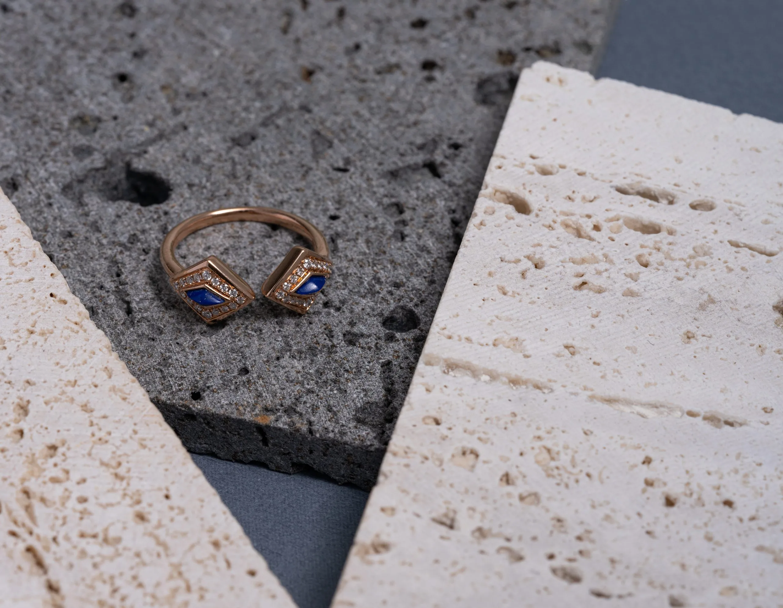 Gold ring resting on a textured stone slab