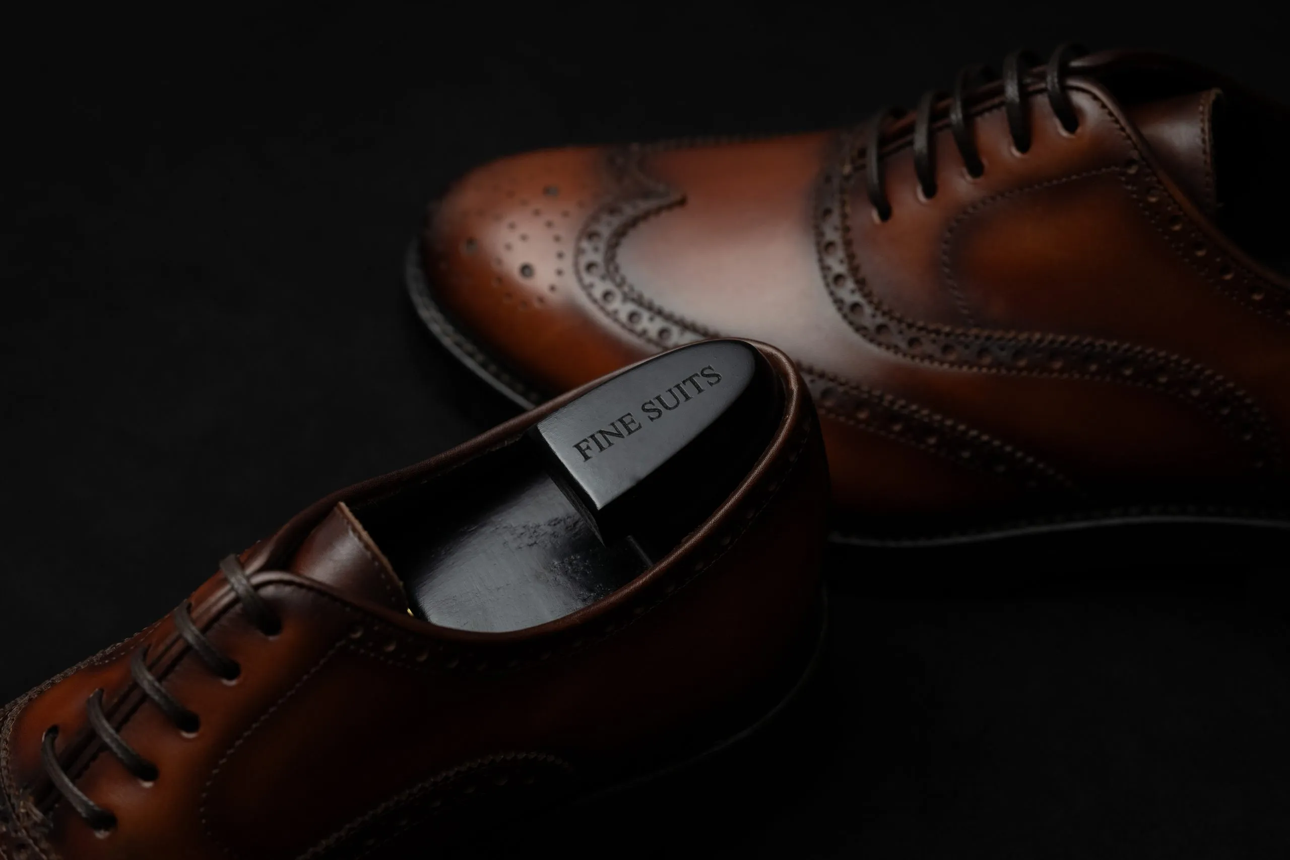 Brown leather brogues in low light
