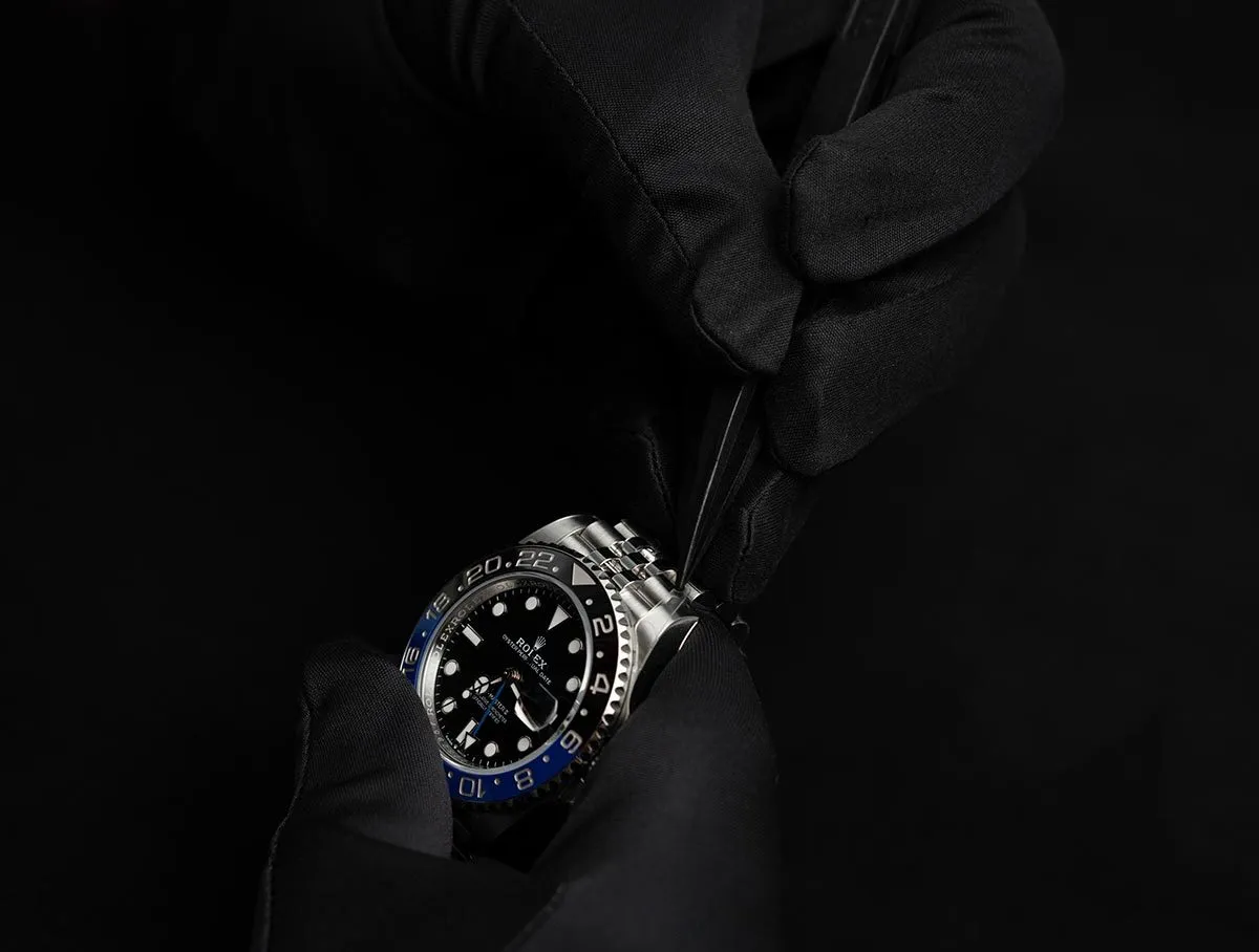 Black diver watch emerging from shadow