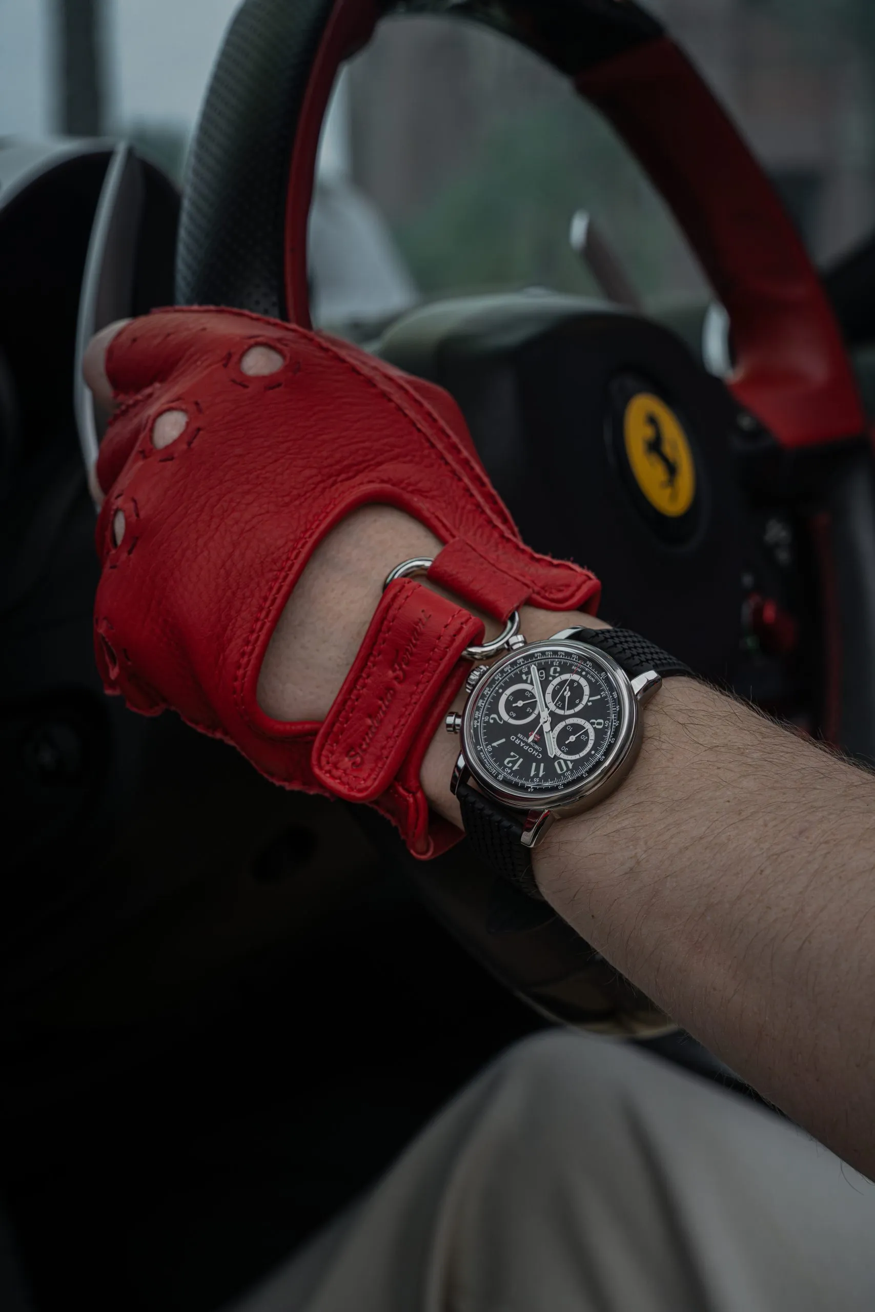 Watch laid over a red racing glove