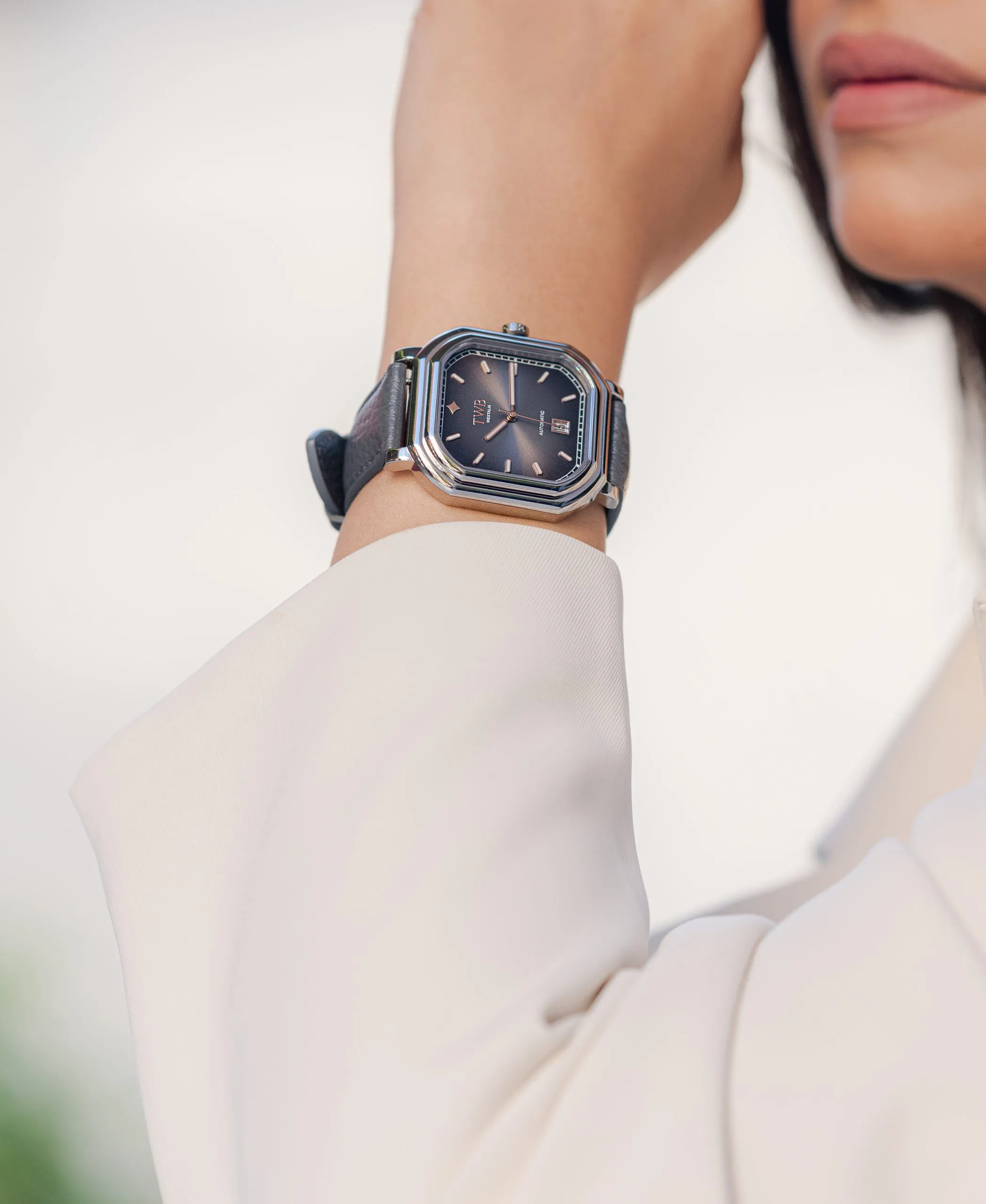 Dark blue watch on the wrist of a man in navy
