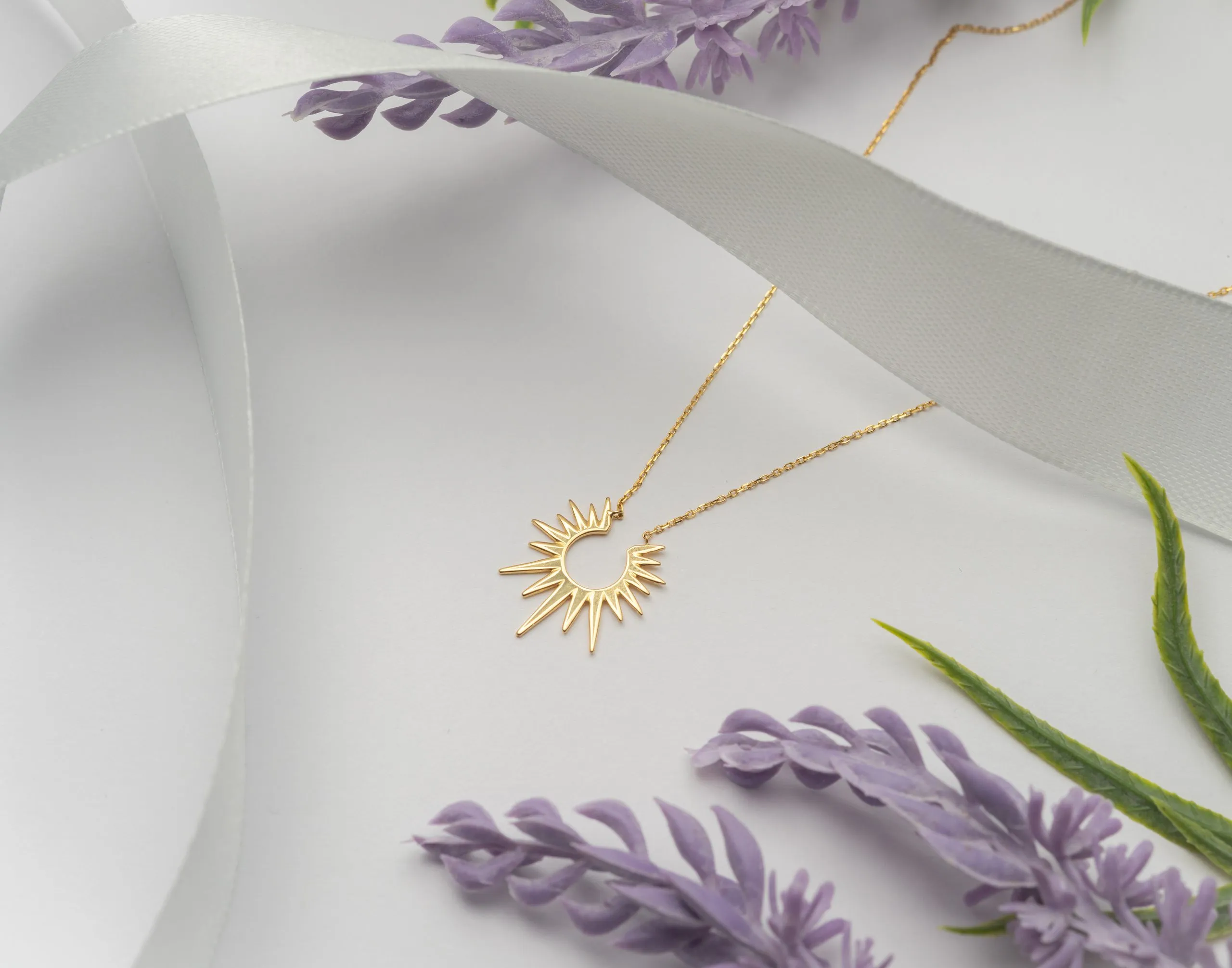 Gold pendant necklace with sprigs of lavender