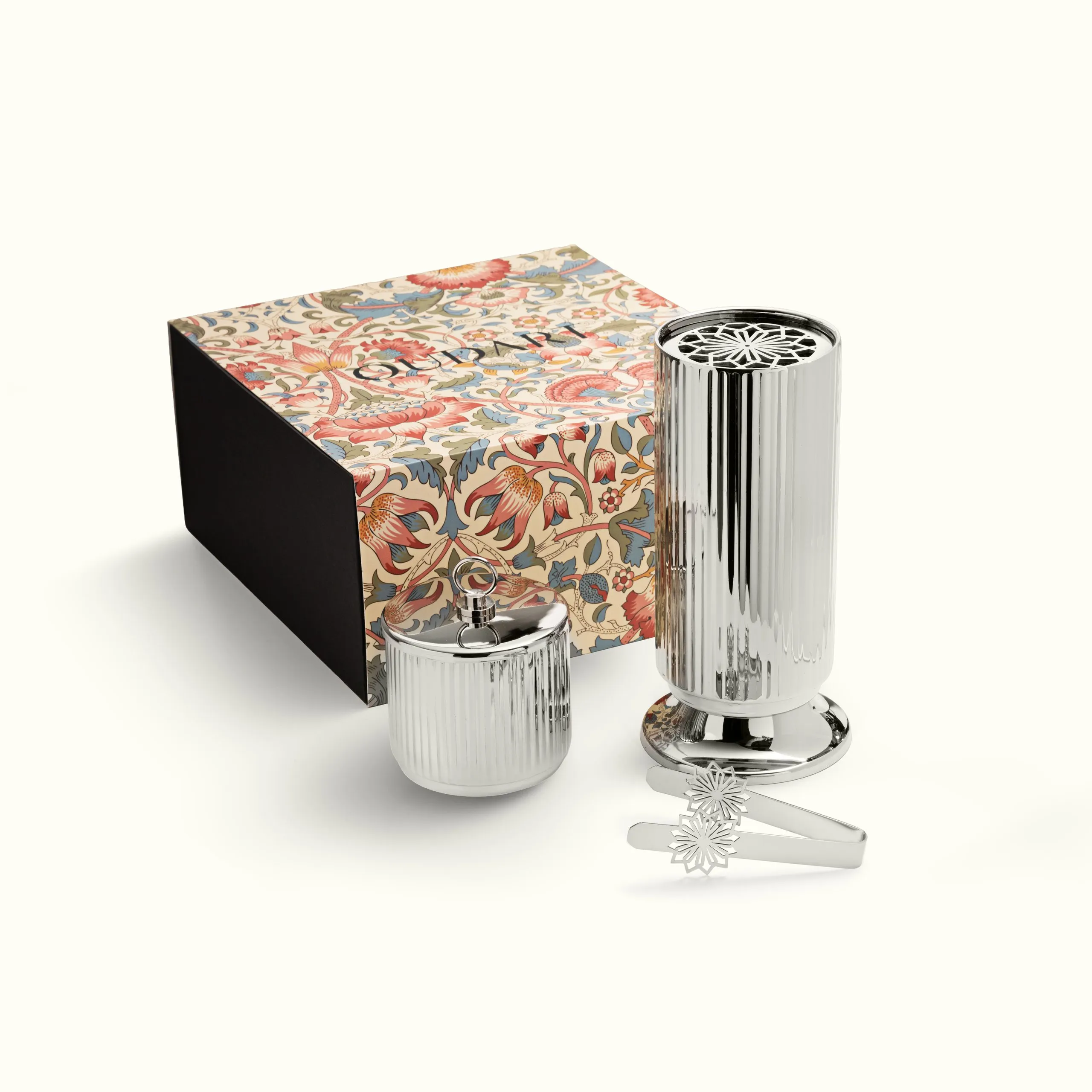 Gift box beside a steel tumbler