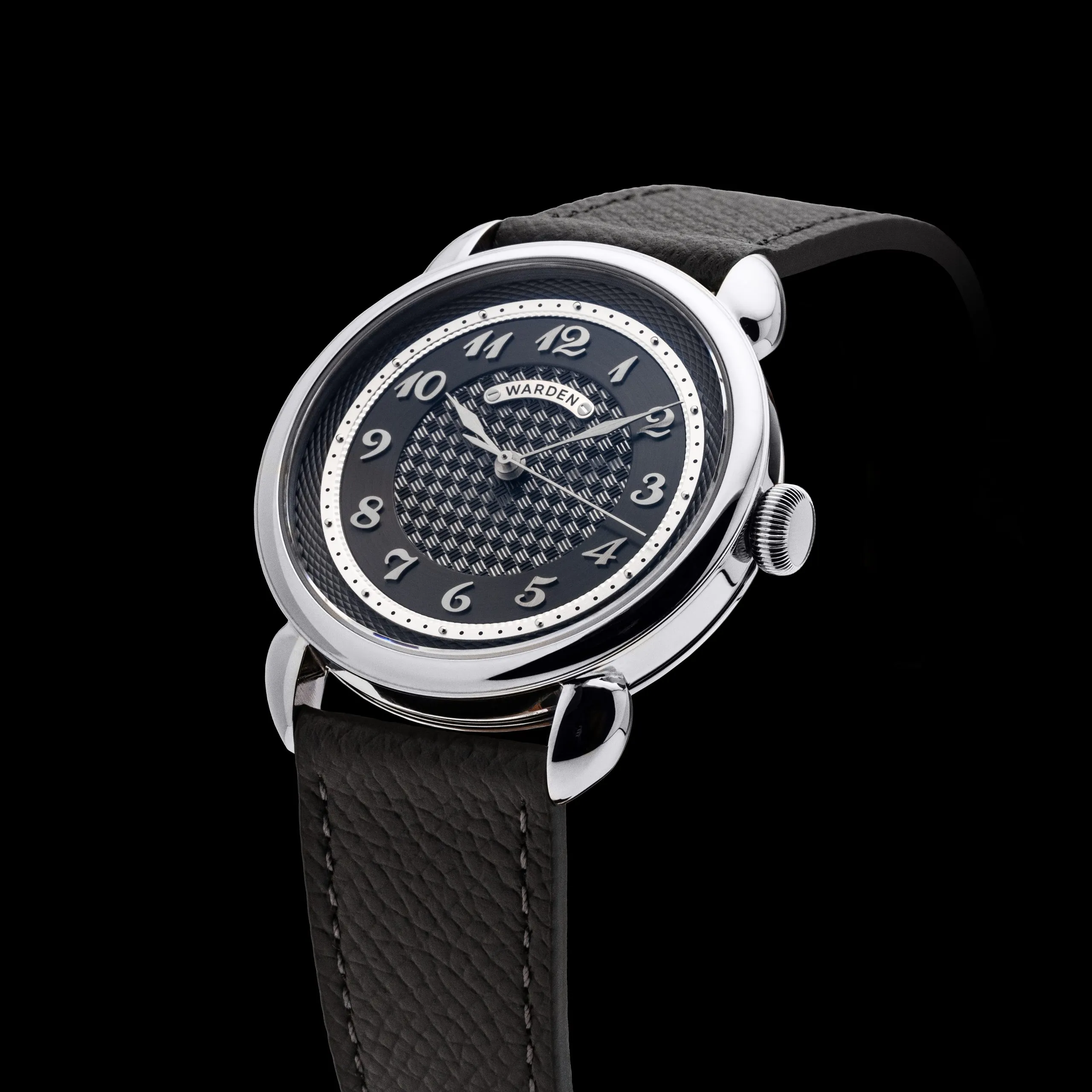 Silver watch with a black dial on dark